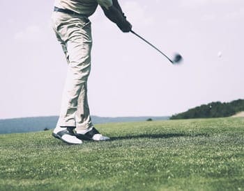 Image of golfer on gold course