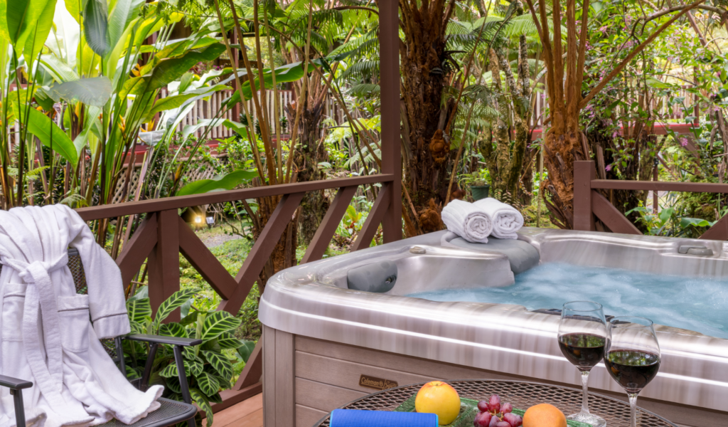 Image of hot tub, robe and glass of wine in hawaii rain forest setting on the big island of hawaii at white lotus garden cottages