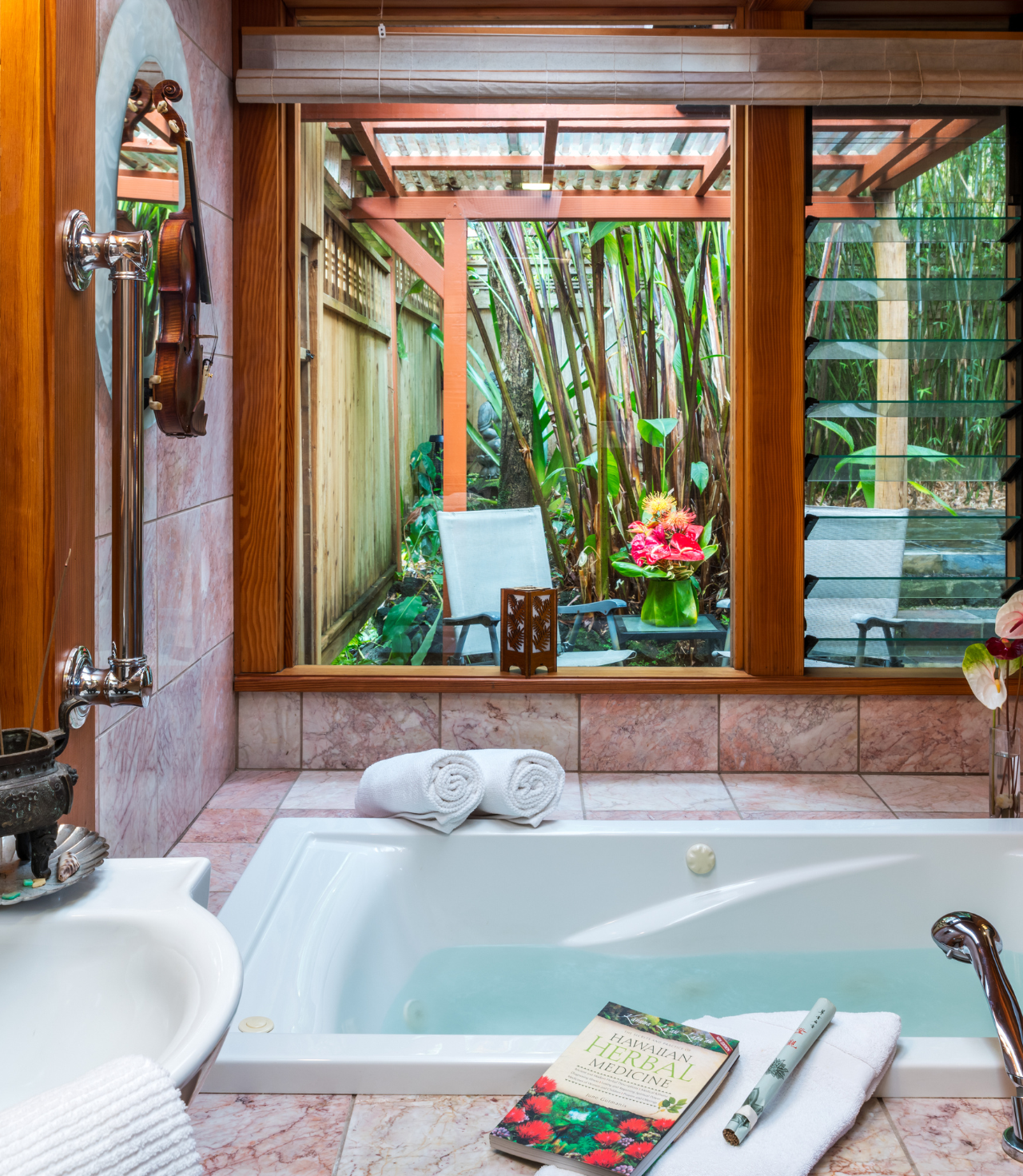 Image of jacuzzi soaking tub with view into hawaii rain forest at Lotus Garden Cottages on the Big Island of Hawaii