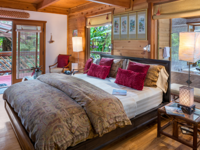 Image of king bed with garden view at Lotus Garden Cottages in Volcano Hawaii